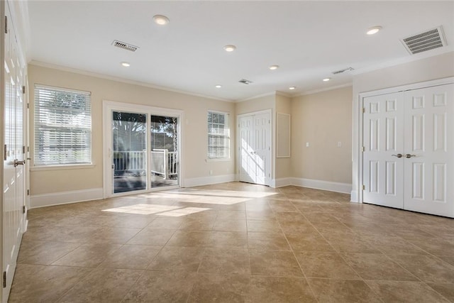 unfurnished room featuring ornamental molding and light tile patterned floors