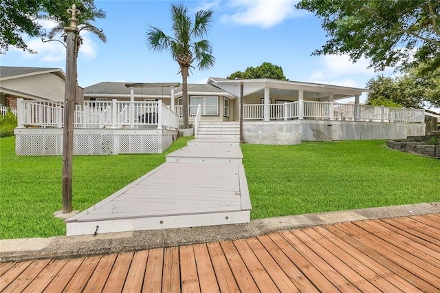 back of house featuring a lawn and a wooden deck