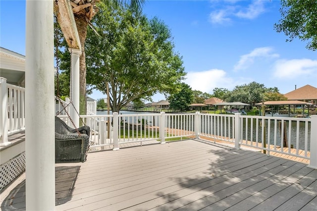 wooden terrace featuring a water view