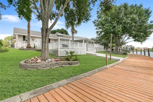 wooden deck featuring a yard and a water view