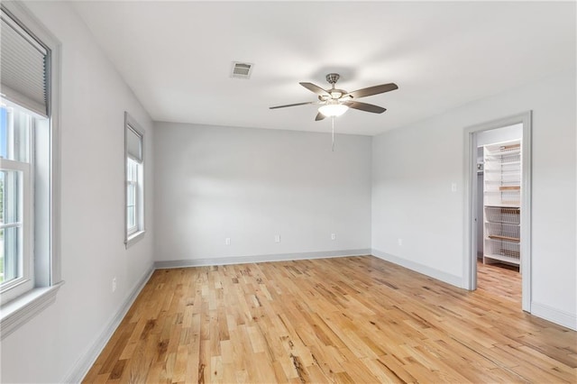 empty room featuring light wood-type flooring and ceiling fan