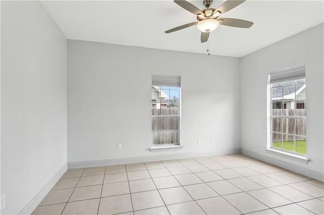 spare room featuring ceiling fan and light tile patterned floors