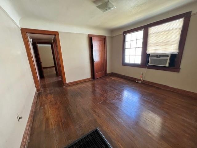 interior space featuring cooling unit and dark hardwood / wood-style floors