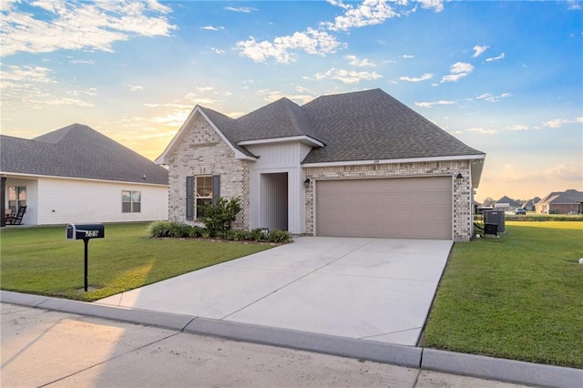 view of front of home featuring a garage and a yard