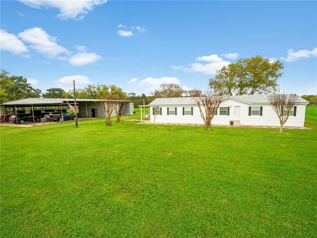 rear view of house featuring a yard