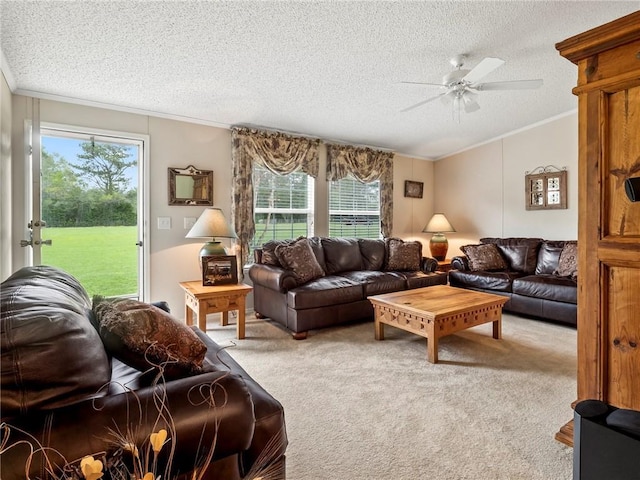 carpeted living room featuring crown molding, vaulted ceiling, ceiling fan, and a textured ceiling