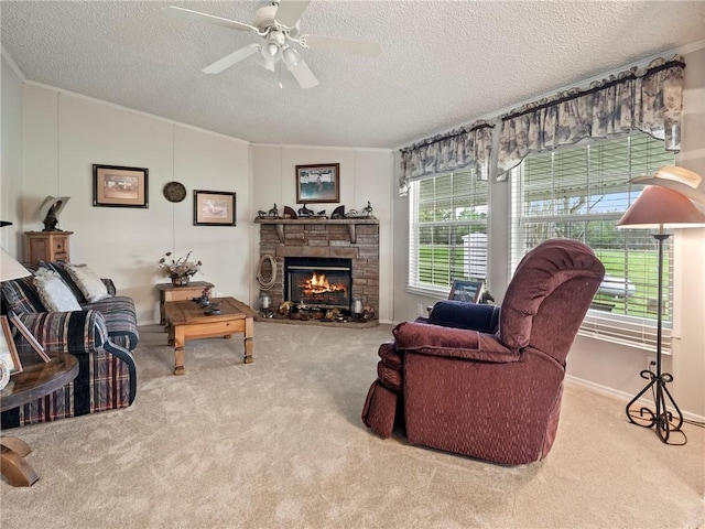 carpeted living room featuring a fireplace, lofted ceiling, ornamental molding, ceiling fan, and a textured ceiling