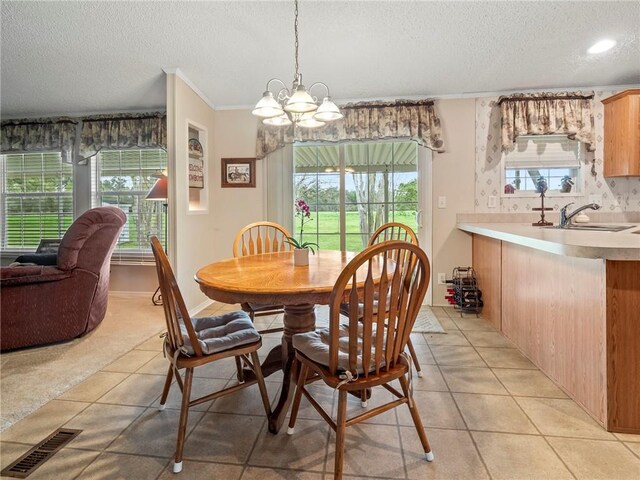 dining area featuring a wealth of natural light, sink, and light tile patterned floors