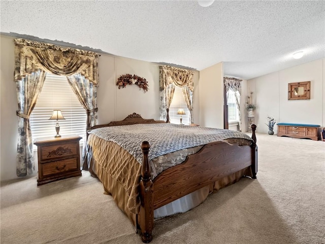 bedroom with vaulted ceiling, light carpet, and a textured ceiling