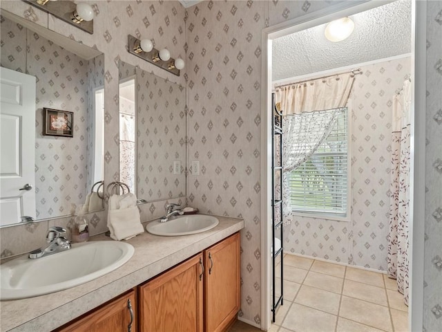 bathroom with vanity, tile patterned flooring, and a textured ceiling