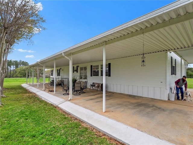 view of patio with a carport and a porch