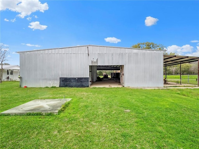 view of outbuilding featuring a lawn