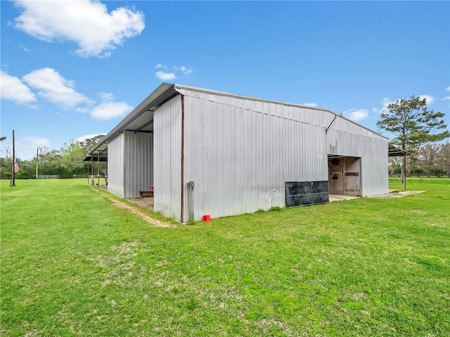 view of outbuilding featuring a yard