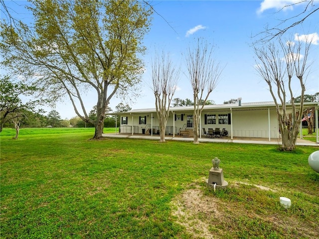 rear view of house with a yard