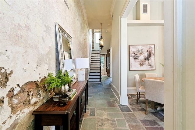 hallway featuring crown molding