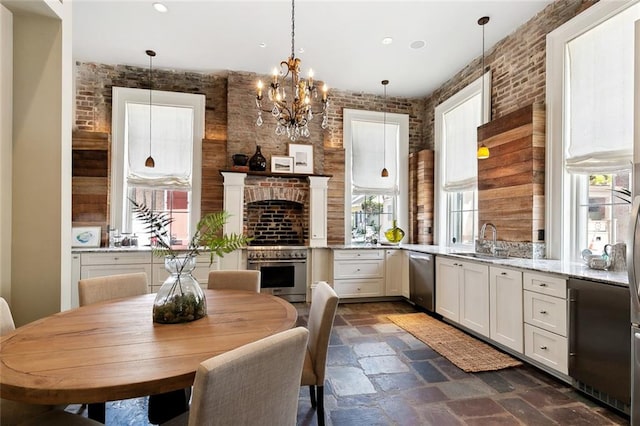 kitchen featuring pendant lighting, white cabinets, and a wealth of natural light