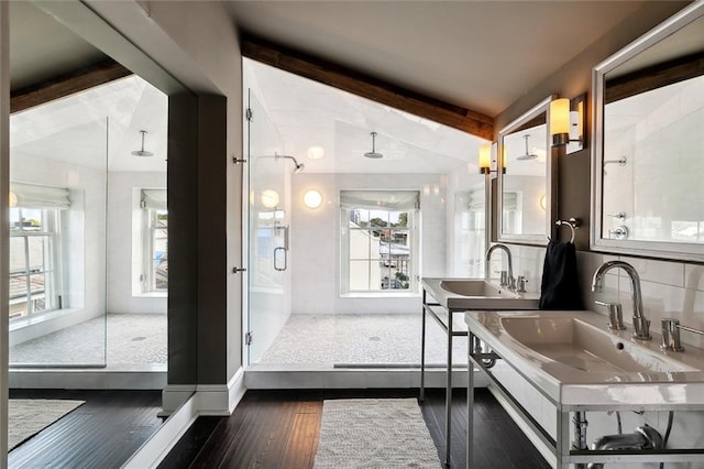 bathroom featuring wood-type flooring, a shower with door, lofted ceiling with beams, and vanity