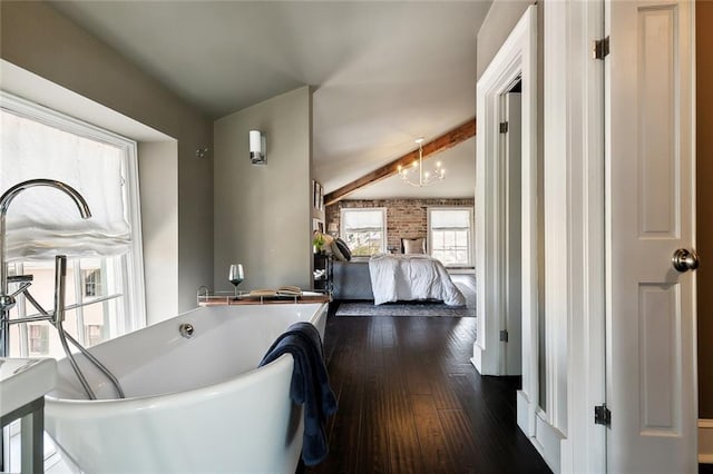 interior space with an inviting chandelier, beam ceiling, and dark hardwood / wood-style flooring