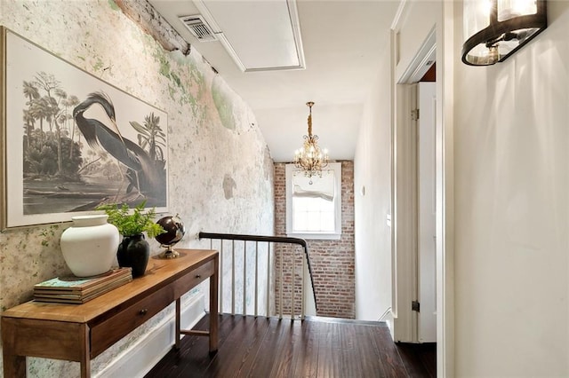 hall with vaulted ceiling, a chandelier, and dark wood-type flooring