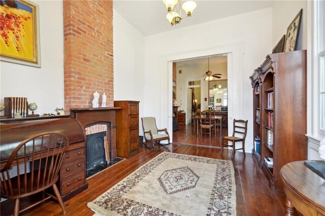 interior space with ceiling fan with notable chandelier and dark hardwood / wood-style floors