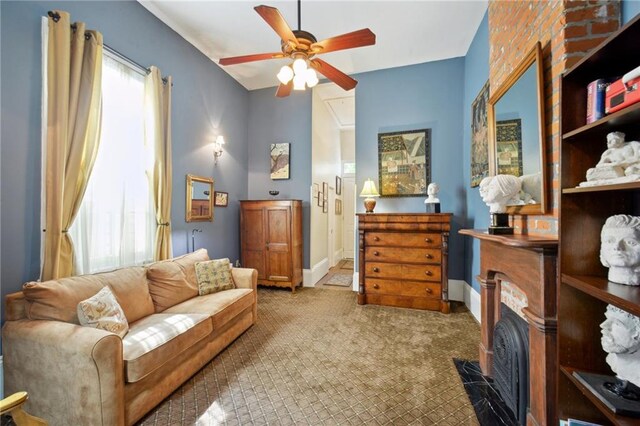 living area with ceiling fan and carpet floors