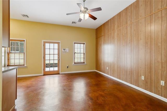 spare room with wooden walls and ceiling fan