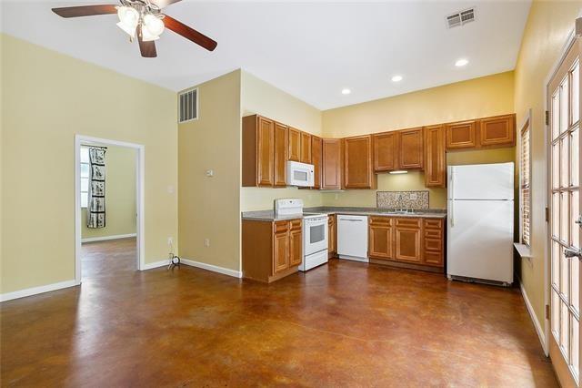 kitchen featuring ceiling fan, sink, and white appliances