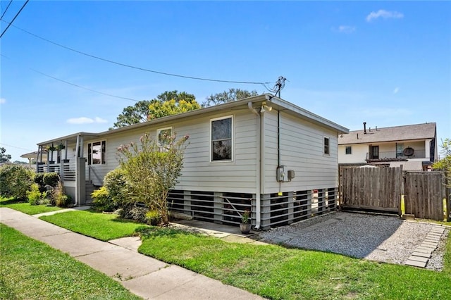 rear view of property featuring a yard