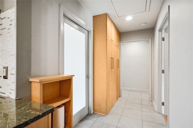 corridor featuring light tile patterned floors