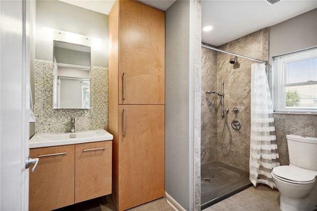 bathroom with backsplash, walk in shower, tile patterned floors, vanity, and toilet