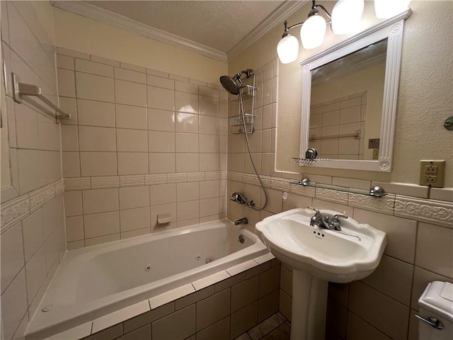 full bathroom featuring a textured ceiling, crown molding, tiled shower / bath combo, toilet, and sink