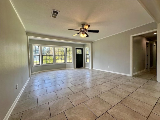 tiled spare room featuring crown molding, a textured ceiling, and ceiling fan