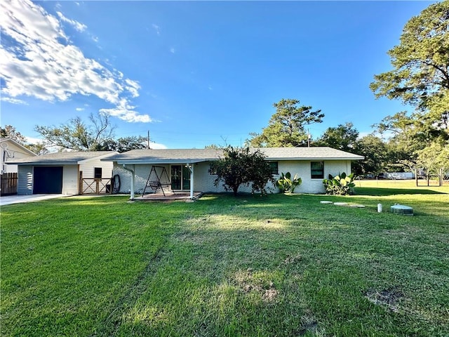 back of property featuring a garage and a lawn