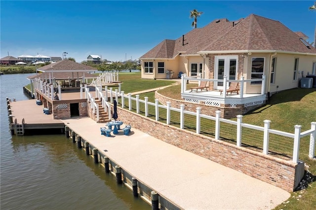 dock area with a yard, central air condition unit, and a water view