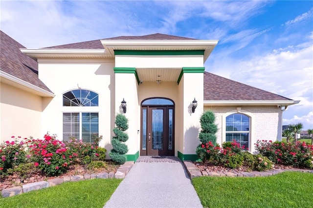 entrance to property featuring a lawn