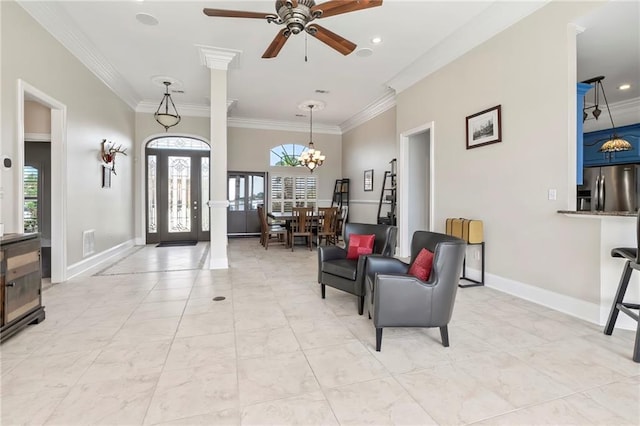 foyer entrance featuring crown molding, ceiling fan with notable chandelier, and plenty of natural light