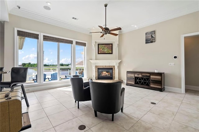 tiled living room featuring ornamental molding, a healthy amount of sunlight, and ceiling fan