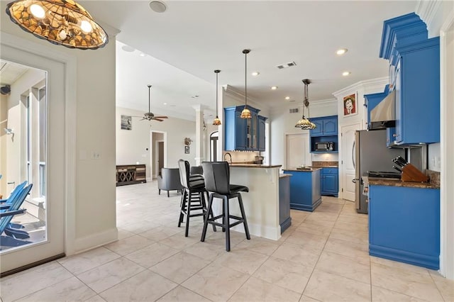 kitchen featuring a kitchen island, ornamental molding, a breakfast bar, pendant lighting, and blue cabinetry