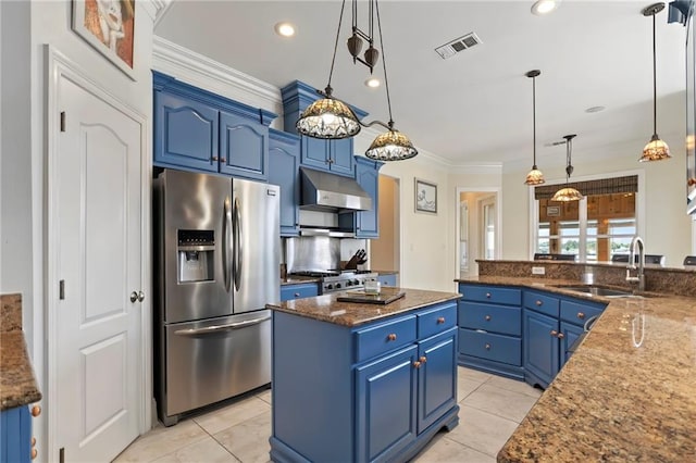 kitchen with stainless steel appliances, dark stone counters, a center island, decorative light fixtures, and blue cabinetry