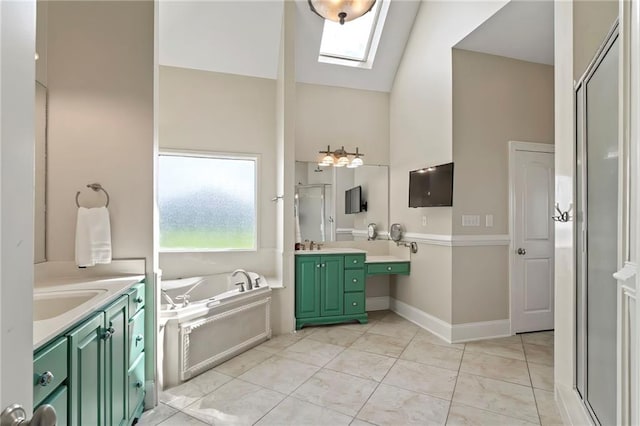 bathroom featuring vanity, vaulted ceiling with skylight, and separate shower and tub