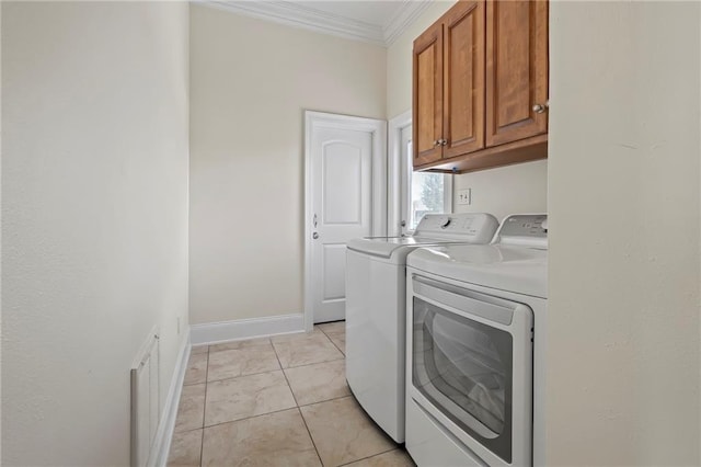 laundry room featuring cabinets, ornamental molding, light tile patterned flooring, and washer and clothes dryer