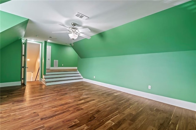 bonus room featuring lofted ceiling, dark hardwood / wood-style floors, and ceiling fan