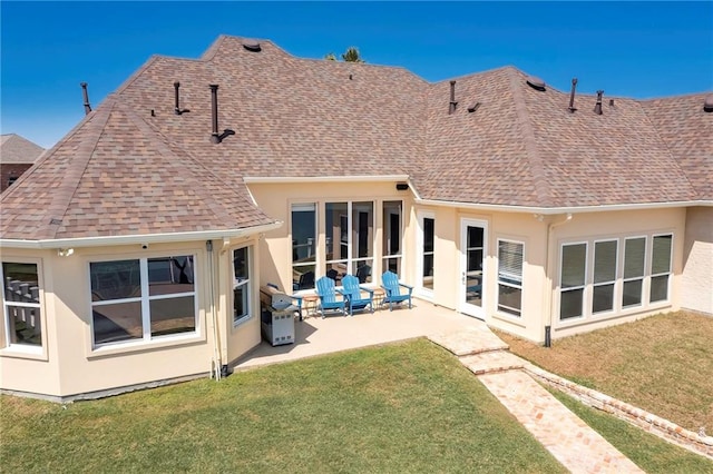 back of property featuring a patio area and a lawn