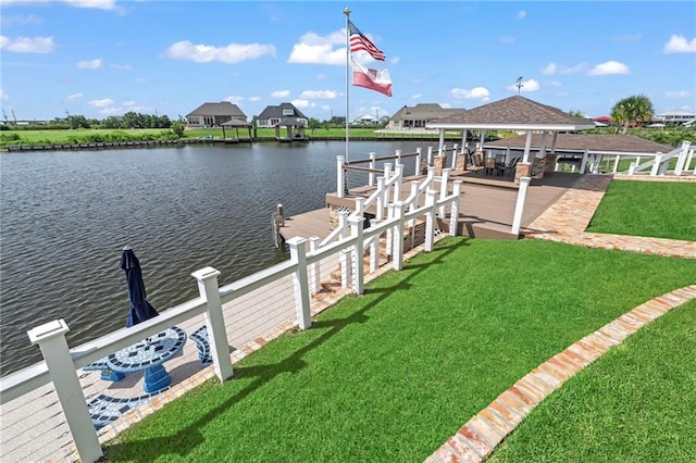 dock area with a yard and a water view