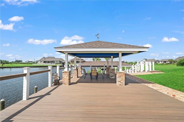 dock area featuring a water view, a gazebo, and a yard