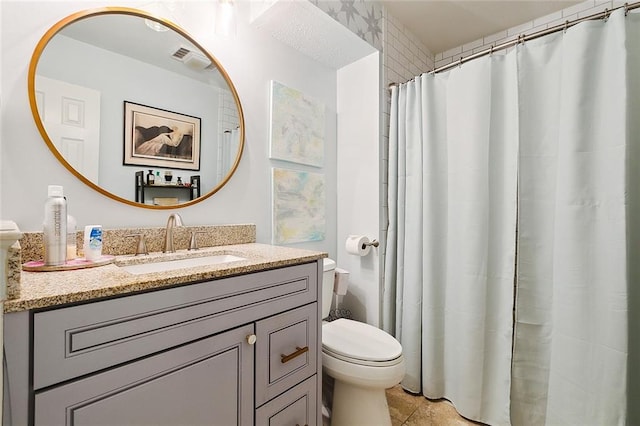 bathroom featuring tile patterned floors, vanity, and toilet