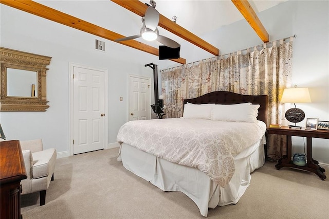 bedroom featuring ceiling fan, light colored carpet, and beam ceiling