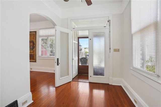 entryway featuring ceiling fan, dark hardwood / wood-style flooring, and a healthy amount of sunlight