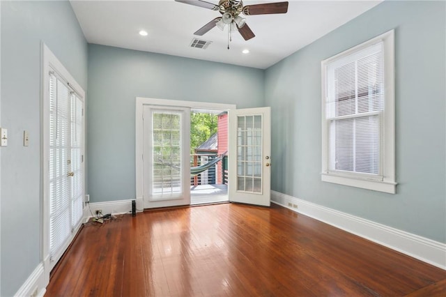 empty room with hardwood / wood-style floors, ceiling fan, and french doors