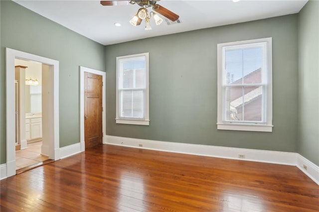 unfurnished bedroom featuring wood-type flooring, ceiling fan, and ensuite bathroom